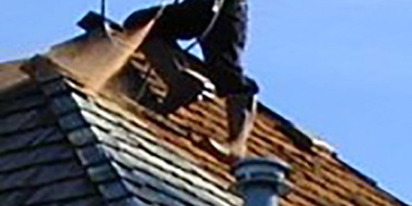 Roof Cleaning Roofer on side of roof