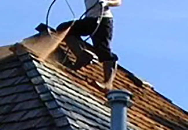 Roofer on side of roof